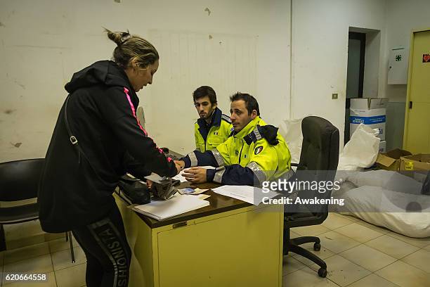 Members of the Civil Protection check the documents before letting homeless go on the special train on November 2, 2016 in Perugia, Italy. A 6.6...