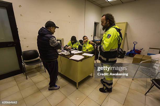 Members of the Civil Protection check the documents before letting homeless go on the special train on November 2, 2016 in Perugia, Italy. A 6.6...