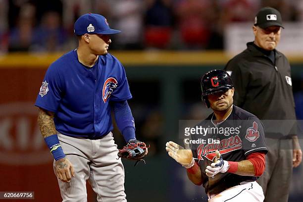 Coco Crisp of the Cleveland Indians reacts at second base after hitting a double during the third inning as Javier Baez of the Chicago Cubs looks on...