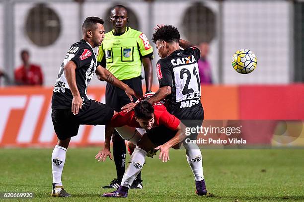 Rafael Carioca and Junior Urso of Atletico MG and Andrigo of Internacional battle for the ball during a match between Atletico MG and Internacional...