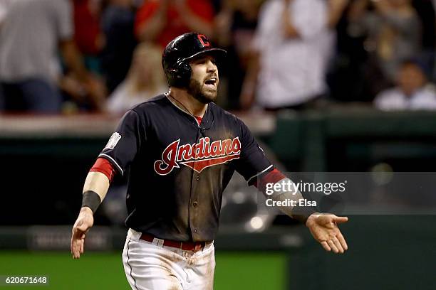 Jason Kipnis of the Cleveland Indians celebrates after scoring a run on a wild pitch thrown by Jon Lester of the Chicago Cubs during the fifth inning...