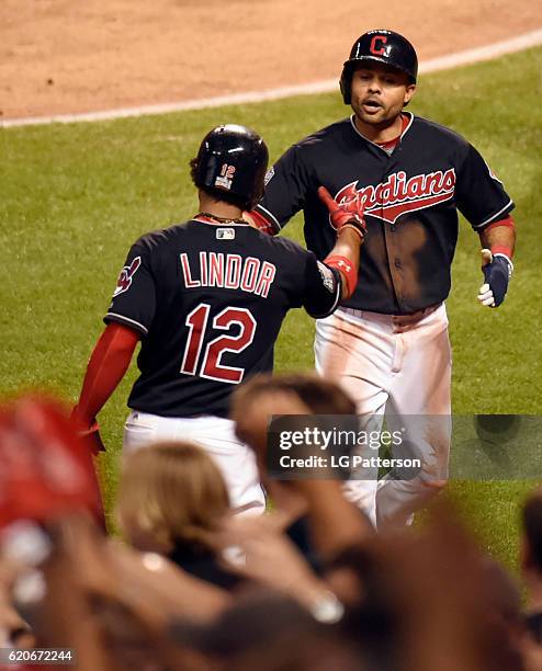 Francisco Lindor greets Coco Crisp of the Cleveland Indians after Crisp scored on a Carlos Santana RBI in the bottom of the third inning of Game 7 of...