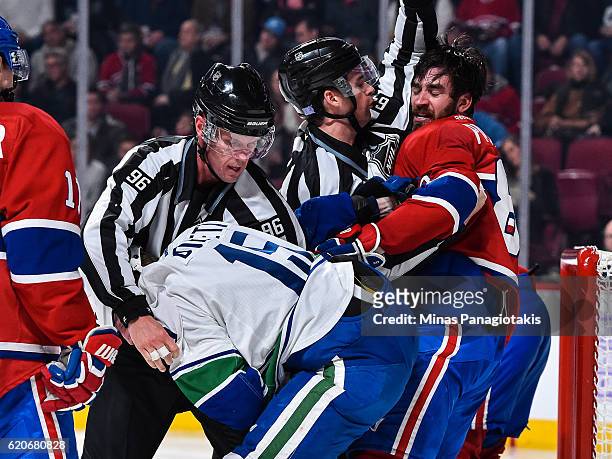 Derek Dorsett of the Vancouver Canucks and Greg Pateryn of the Montreal Canadiens get into a pushing match during the NHL game at the Bell Centre on...
