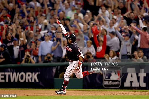 Rajai Davis of the Cleveland Indians celebrates after hitting a two-run home run during the eighth inning to tie the game 6-6 against the Chicago...