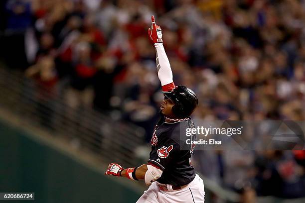 Rajai Davis of the Cleveland Indians celebrates after hitting a two-run home run during the eighth inning to tie the game 6-6 against the Chicago...