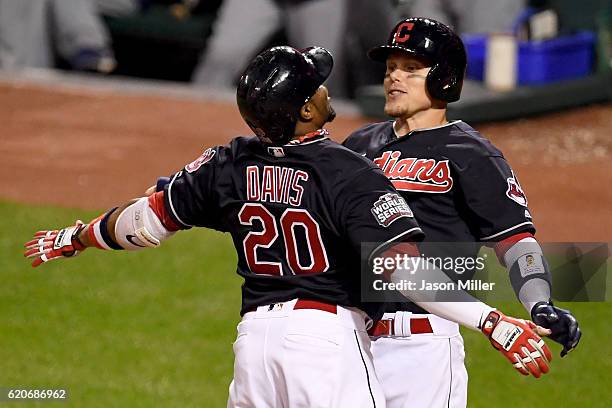 Rajai Davis of the Cleveland Indians celebrates with Brandon Guyer after hitting a two-run home run during the eighth inning to tie the game 6-6...