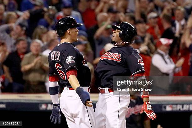 Rajai Davis of the Cleveland Indians celebrates with Brandon Guyer after hitting a two-run home run during the eighth inning to tie the game 6-6...