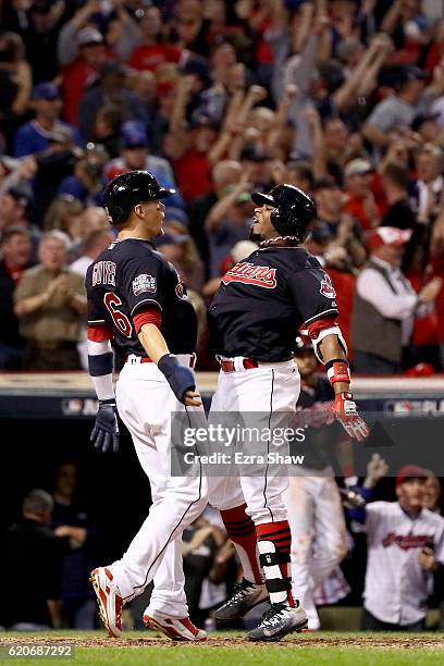 Rajai Davis of the Cleveland Indians celebrates with Brandon Guyer after hitting a two-run home run during the eighth inning to tie the game 6-6...