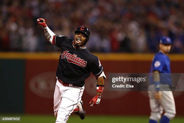 Rajai Davis of the Cleveland Indians celebrates as he runs the bases after hitting a two-run home run during the eighth inning to tie the game 6-6...