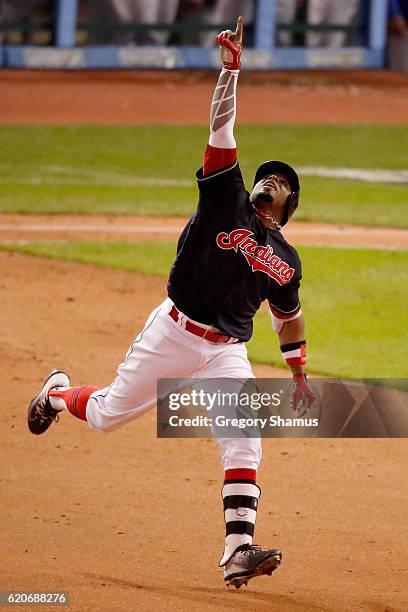 Rajai Davis of the Cleveland Indians celebrates as he runs the bases after hitting a two-run home run during the eighth inning to tie the game 6-6...