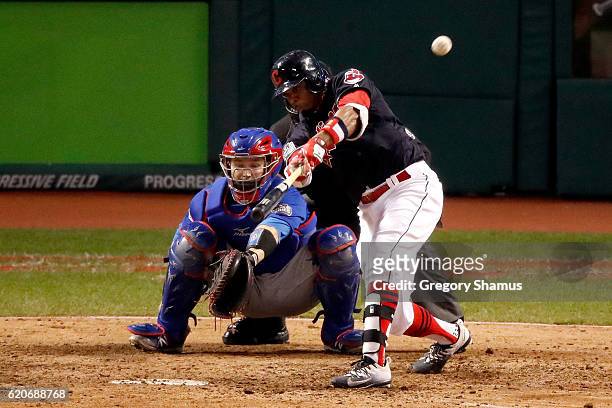 Rajai Davis of the Cleveland Indians hits a two-run home run during the eighth inning to tie the game 6-6 against the Chicago Cubs in Game Seven of...