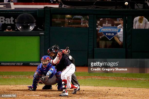 Rajai Davis of the Cleveland Indians hits a two-run home run during the eighth inning to tie the game 6-6 against the Chicago Cubs in Game Seven of...