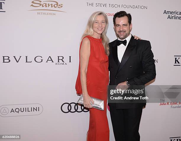 Ester Velo Van Hulst and International Communications Director for Bulgari Stephane Gerschel wears Bulgari to the Elton John AIDS Foundation's 15th...