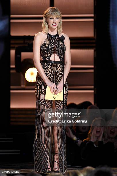 Taylor Swift presents award onstage at the 50th annual CMA Awards at the Bridgestone Arena on November 2, 2016 in Nashville, Tennessee.