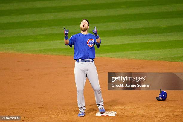 Ben Zobrist of the Chicago Cubs celebrates after he hits a RBI double in the 10th inning against the Cleveland Indians in Game Seven of the 2016...