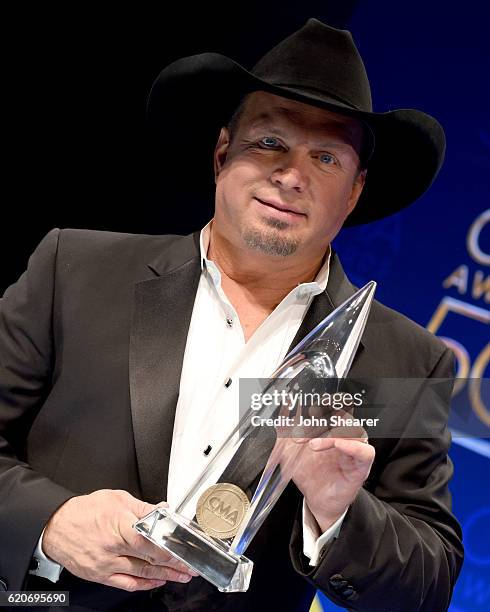 Garth Brooks poses backstage with his Entertainer of the Year award backstage at the 50th annual CMA Awards at the Bridgestone Arena on November 2,...