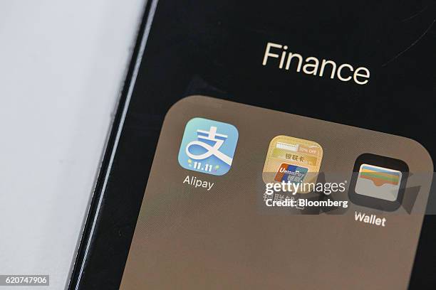 Application icons for Ant Financial Services Group's Alipay, an affiliate of Alibaba Group Holding Ltd., left, China UnionPay Co., center, and Apple...