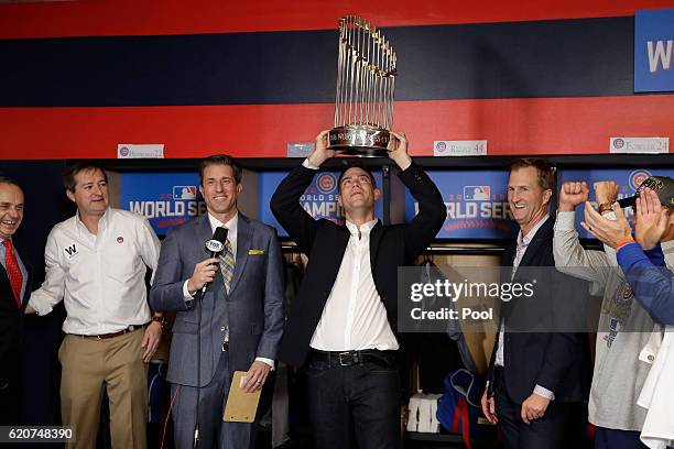 President of Baseball Operations for the Chicago Cubs Theo Epstein holds The Commissioner's Trophy after the Chicago Cubs defeated the Cleveland...