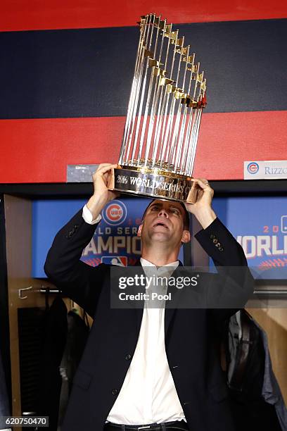 President of Baseball Operations for the Chicago Cubs Theo Epstein reacts with The Commissioner's Trophy after the Chicago Cubs defeated the...