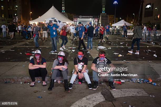 Cleveland Indians fans sit outside of Progressive Field after the Chicago Cubs beat the Cleveland Indians in game 7 of the World Series in the early...