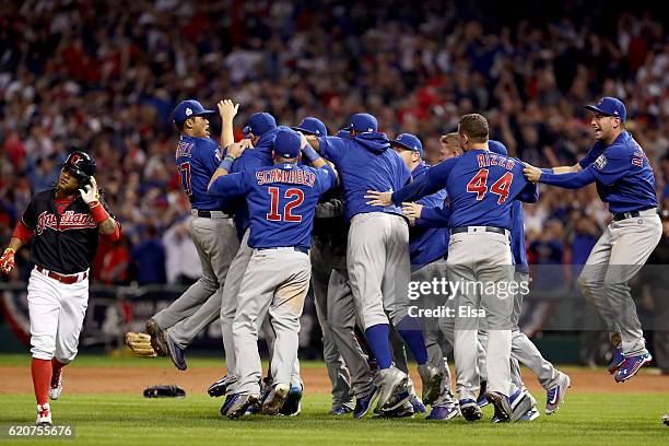 Michael Martinez of the Cleveland Indians reacts as the Chicago Cubs celebrate after defeating the Indians 8-7 in Game Seven of the 2016 World Series...