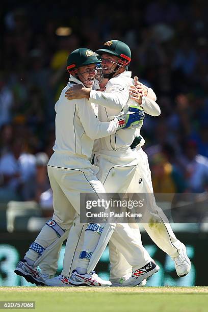 Shaun Marsh of Australia is congratulated by Peter Nevill and Steve Smith after taking a catch to dismiss Temba Bavuma of South Africa during day one...