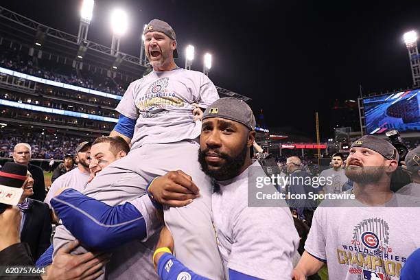 Chicago Cubs first baseman Anthony Rizzo and Chicago Cubs right fielder Jason Heyward hold up teammate David Ross after winning game 7 of the 2016...