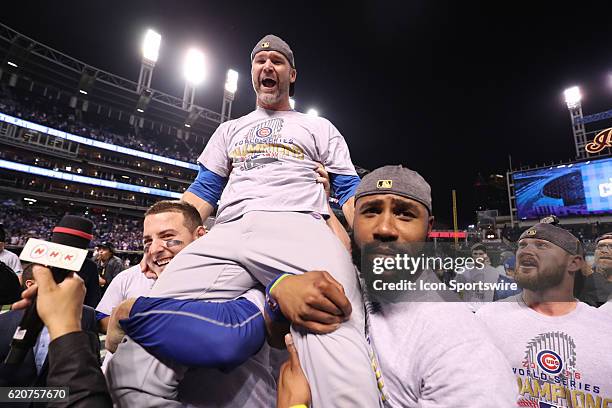 Chicago Cubs first baseman Anthony Rizzo and Chicago Cubs right fielder Jason Heyward hold up teammate David Ross after winning game 7 of the 2016...