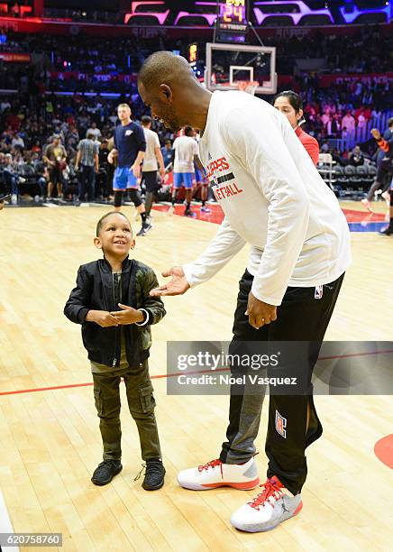 Mustard's son meets Chris Paul at a basketball game between the Oklahoma City Thunder and the Los Angeles Clippers at Staples Center on November 2,...