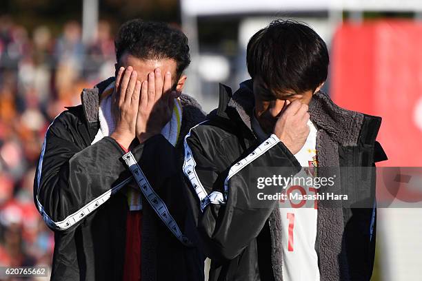 Marcus Tulio Tanaka and Seigo Narazaki of Nagoya Grampus look on after their relegation to the second division after the J.League match between...