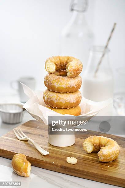 a stack of sugar glazed donuts on white background. - glazed food - fotografias e filmes do acervo