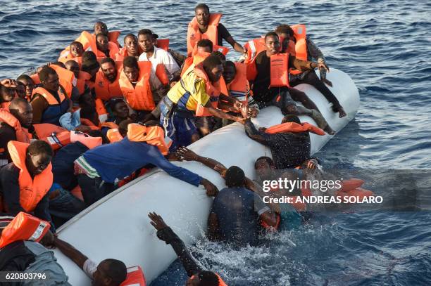 Migrants and refugees panic as they fall in the water during a rescue operation of the Topaz Responder rescue ship run by Maltese NGO Moas and...