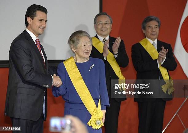 Japan - Mexican President Enrique Pena Nieto awards the Order of Aztec Eagle to former U.N. High Commissioner for Refugees Sadako Ogata, Mazda Motor...