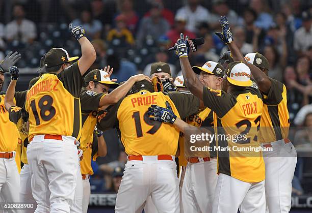 Former MLB outfielder Curtis Pride is mobbed by teammates at home plate after hitting a home run during the MLB 2016 All-Star Legends and Celebrity...