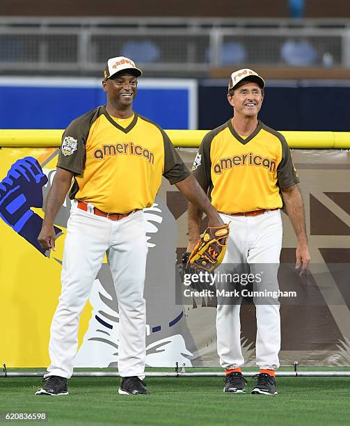 Former MLB outfielders Curtis Pride and Fred Lynn stand together in the outfield during the MLB 2016 All-Star Legends and Celebrity Softball Game at...