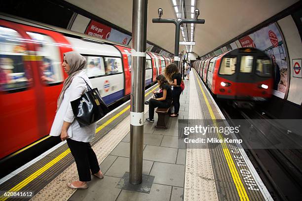 TfL underground trains come and go on the double platforms at Clapham Common tube station on the Northern Line in London, England, United Kingdom.