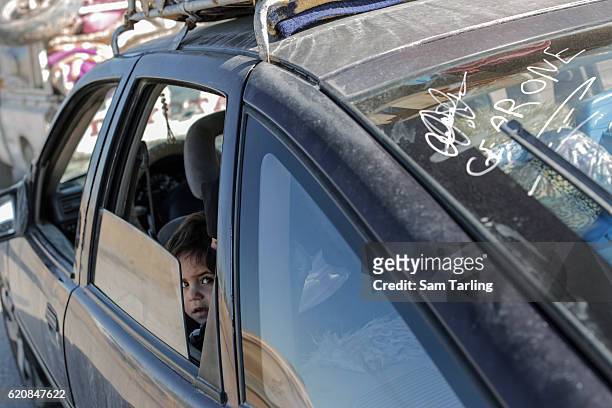 Civilians fleeing neighbourhoods in Eastern Mosul that have been re-taken by Iraqi forces wait at a checkpoint outside Gogjoli, the city's...