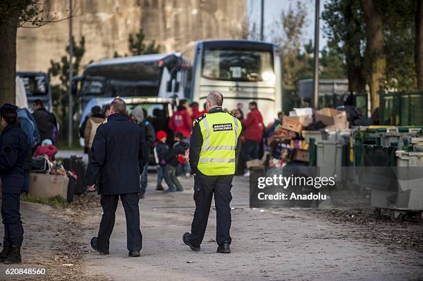 British immigration police enforcemement frames the refugees in Calais, on November 3, 2016. Over 350 women and Their children, still living at the...