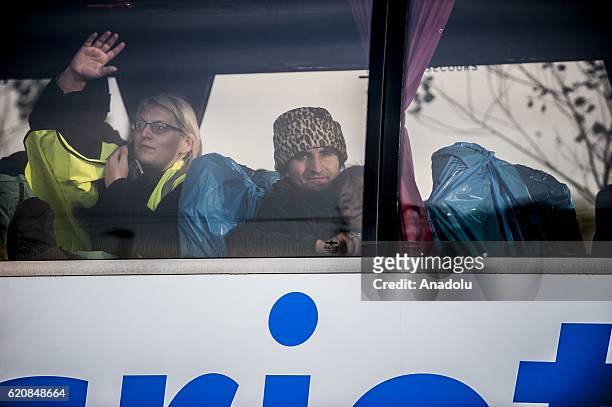 Refugee with his daughter look through the window of the bus leaving the center "Jules Ferry" in Calais, on November 3, 2016. Over 350 women and...