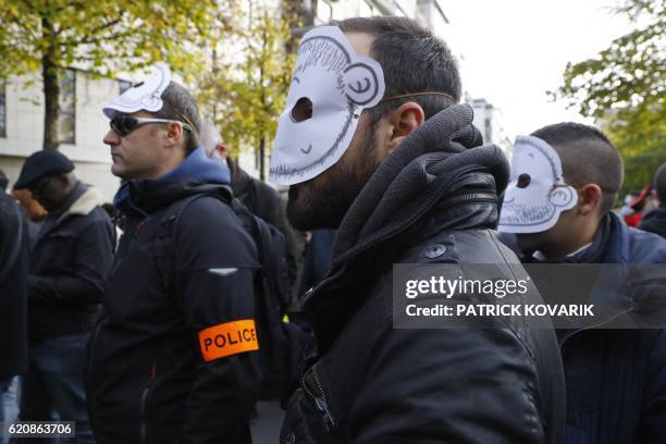 Masked policemen take part in a protest outside the headquarters of the Inspection Generale de la Police Nationale , a sub-directorate responsible...