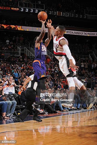 Eric Bledsoe of the Phoenix Suns shoots the game winning three point basket in overtime over Damian Lillard of the Portland Trail Blazers on November...