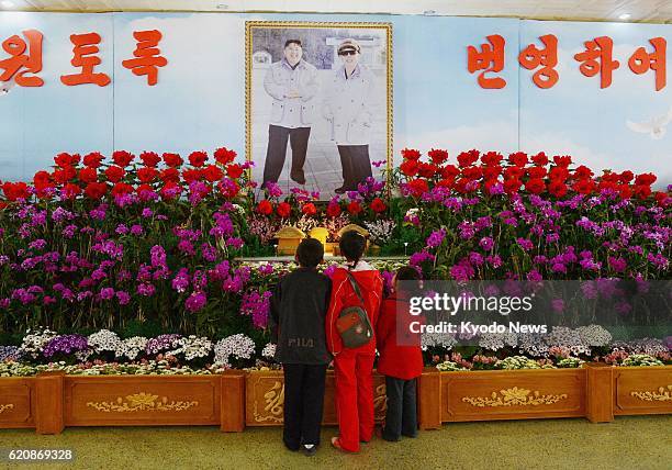 North Korea - Photo of North Korean leader Kim Jong Un and his father and predecessor Kim Jong Il is on display at a flower exhibition in Pyongyang...