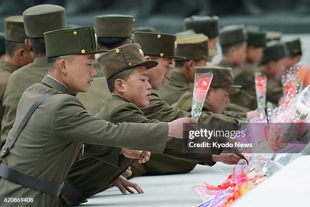 North Korea - Soldiers lay flowers on Mansu Hill in Pyongyang, where bronze statues of North Korean founder Kim Il Sung and his son and late leader...