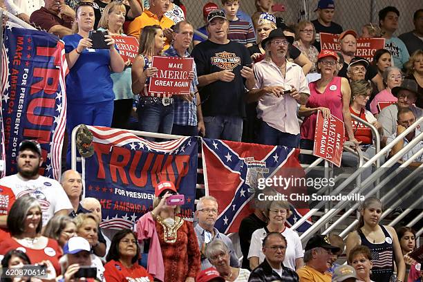 Supporters of Republican presidential nominee Donald Trump listen to him during a campaign rally at the Jacksonville Equestrian Center November 3,...