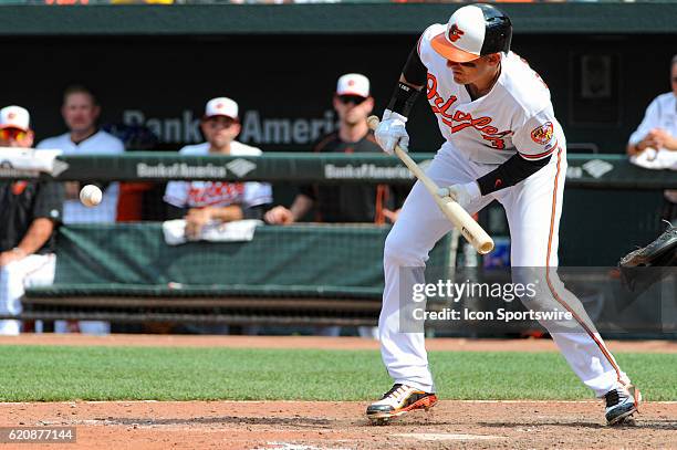 Baltimore Orioles third baseman Ryan Flaherty hits a sacrifice bunt against the Cleveland Indians at Orioles Park at Camden Yards in Baltimore, MD....