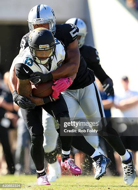 Malcolm Smith of the Oakland Raiders tackles Rashad Greene of the Jacksonville Jaguars during the game at EverBank Field on October 23, 2016 in...
