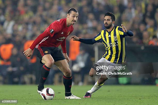 Zlatan Ibrahimovic of Manchester United runs with the ball under pressure from Alper Potuk of Fenerbahce during the UEFA Europa League Group A match...