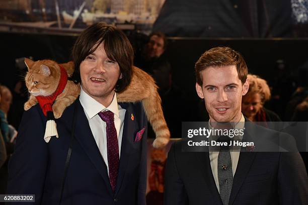 James Bowen with Bob the cat and Luke Treadway attend the UK Premiere of "A Street Cat Named Bob" in aid of Action On Addiction on November 3, 2016...