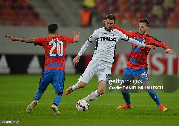 Florin Lovin of FC Astra Giurgiu vies for the ball with Ergys Kace and Jakub Hromada of FC Viktoria Plzen during the UEFA Europa League group E...