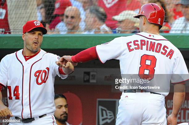 Washington Nationals shortstop Danny Espinosa is congratulated by center fielder Chris Heisey after scoring against the Chicago Cubs at Nationals...
